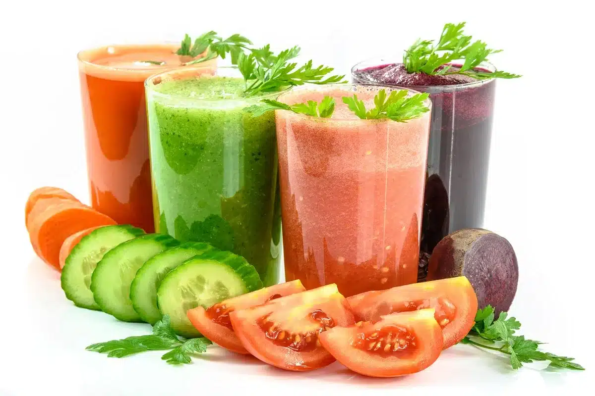 Verre de jus de carotte sur un plan de travail de cuisine, lumière du jour